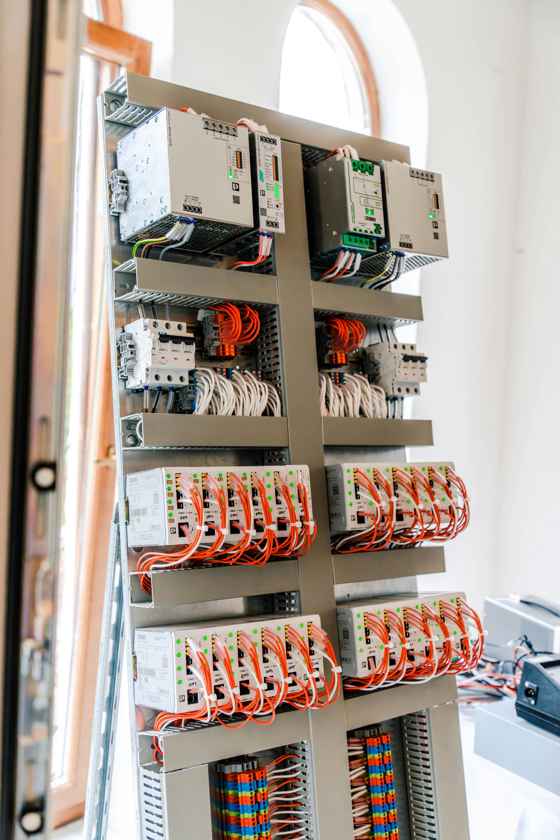 An open electrical control panel with numerous wires and components